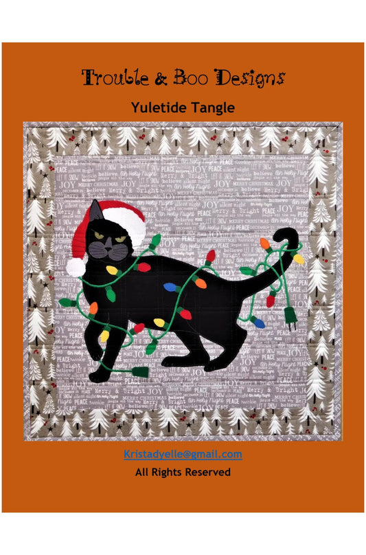 Festive black cat illustration with Christmas lights and a Santa hat on a gray background, framed by trees, with 'Trouble & Boo Designs' branding.