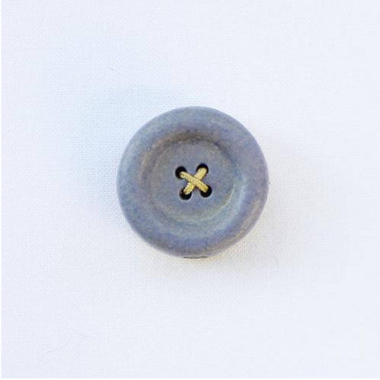 Round button with a gold center on a white background