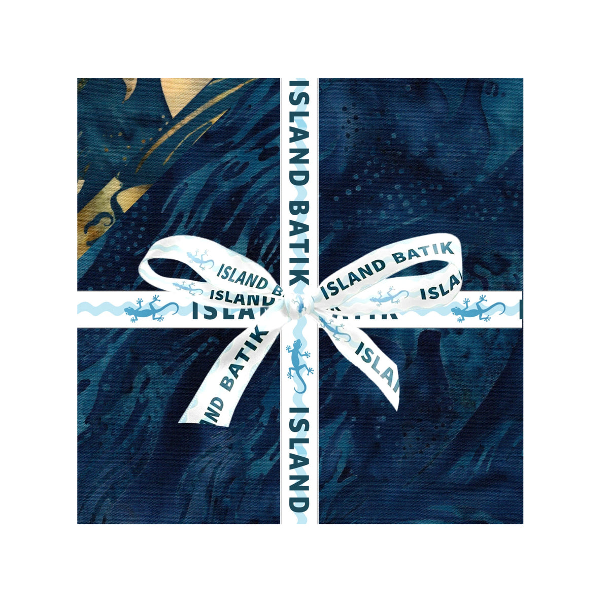 A square of dark blue batik-patterned fabric squares and tied with a white ribbon printed with 'ISLAND BATIK', shown on a white background.