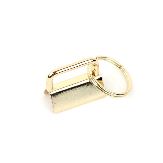 Gold keychain with rectangular tag on a white background