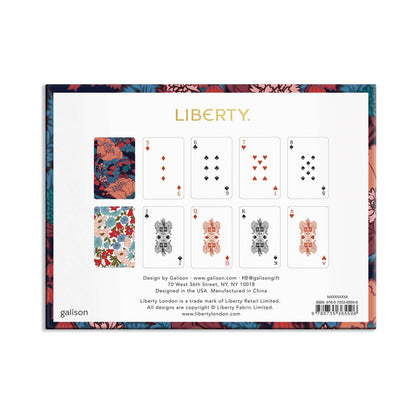 A square product card for a Liberty playing card deck, featuring a white center with eight illustrated playing cards and decorative floral border artwork. Visible text includes the brand name LIBERTY and maker name gallison.