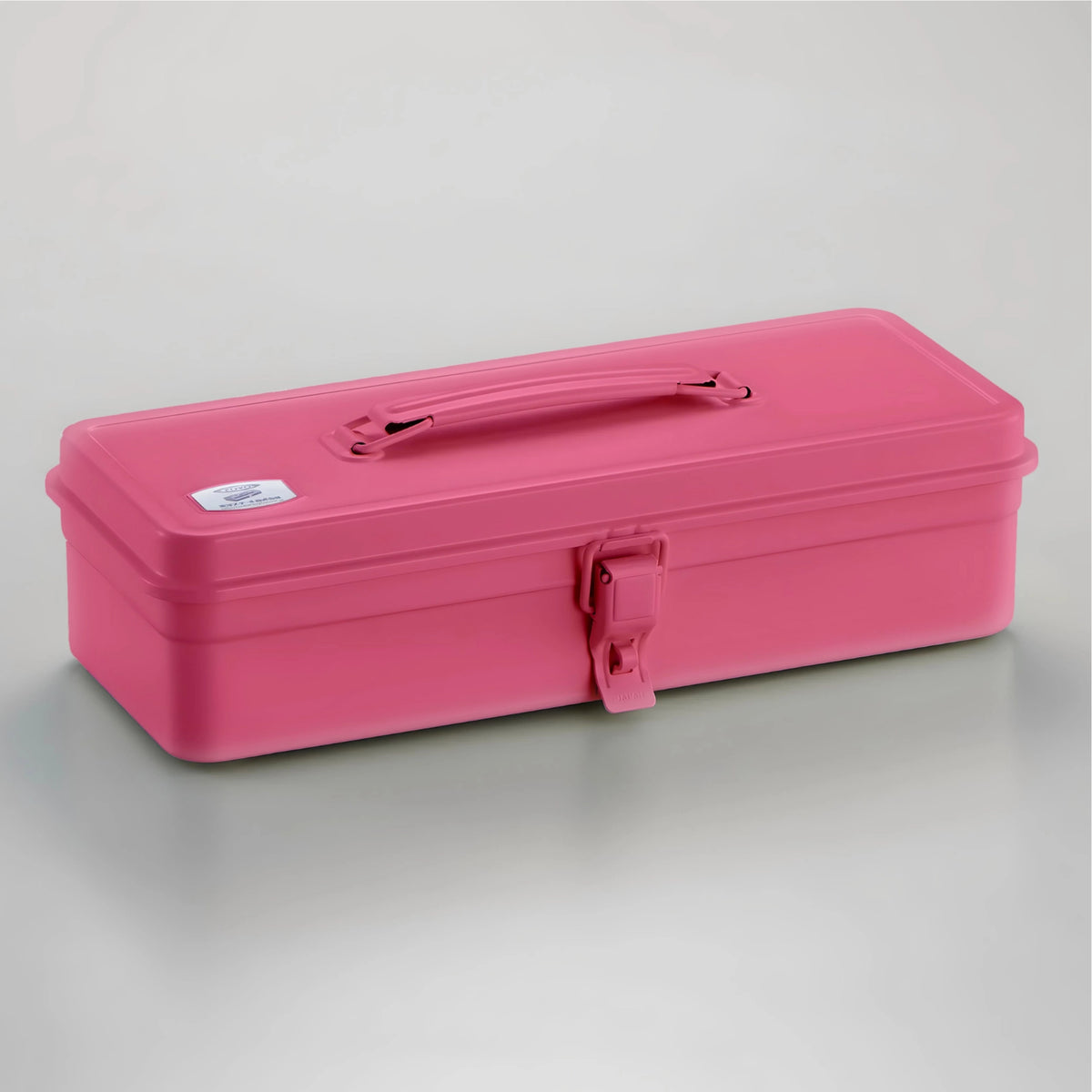 A bright pink rectangular metal storage box with a carrying handle and latch closure, photographed on a clean light gray studio background.