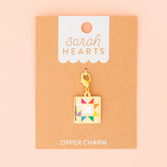 Colorful quilt charm on a 'Sarah Hearts' branded card with a pink background