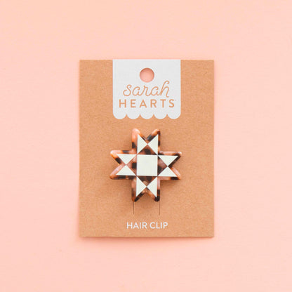 Hair clip on a 'sarah HEARTS' branded card against a pink background