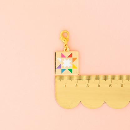 Colorful charm with a star design on a pink background