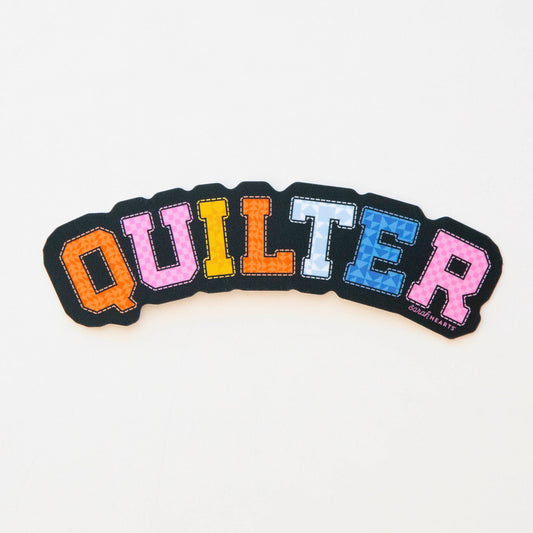 Colorful sticker with the word 'QUILTER' on a white background