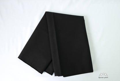 Kona Cotton Solids Black fabric folded