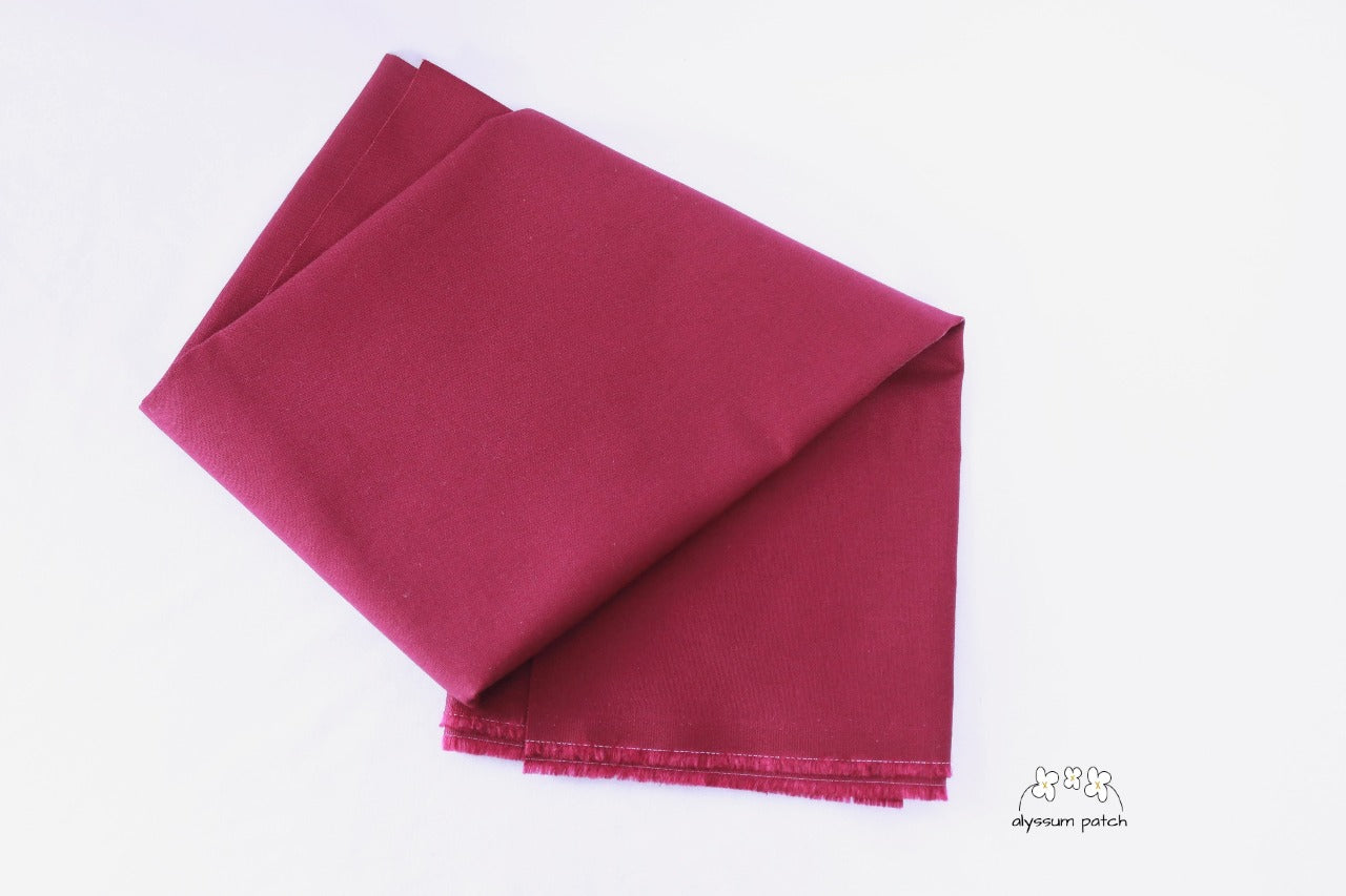 Kona Cotton Solids Bordeaux fabric folded