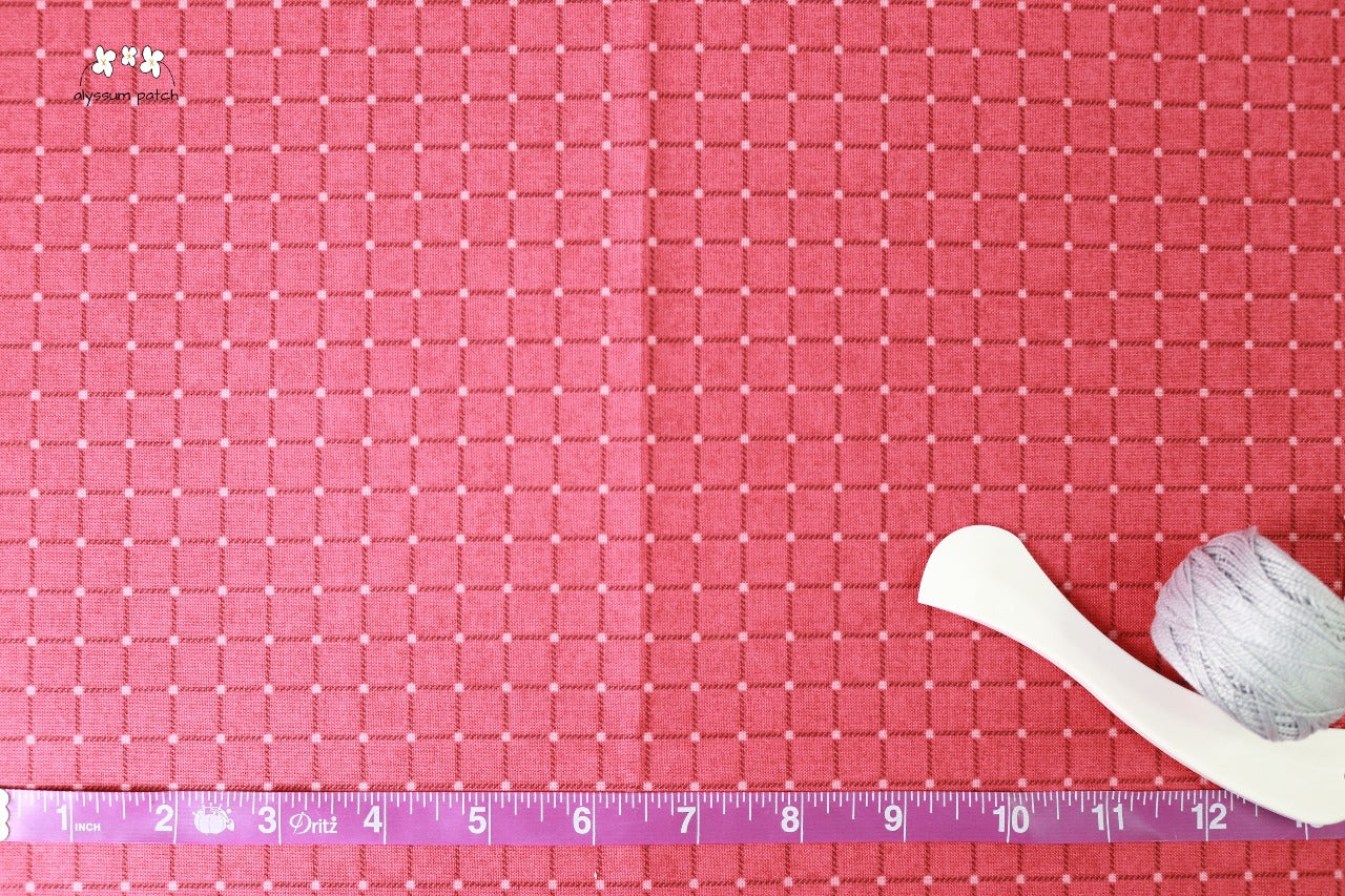 Brick Criss Cross fabric with measuring tape and sewing tools to show scale of image pattern