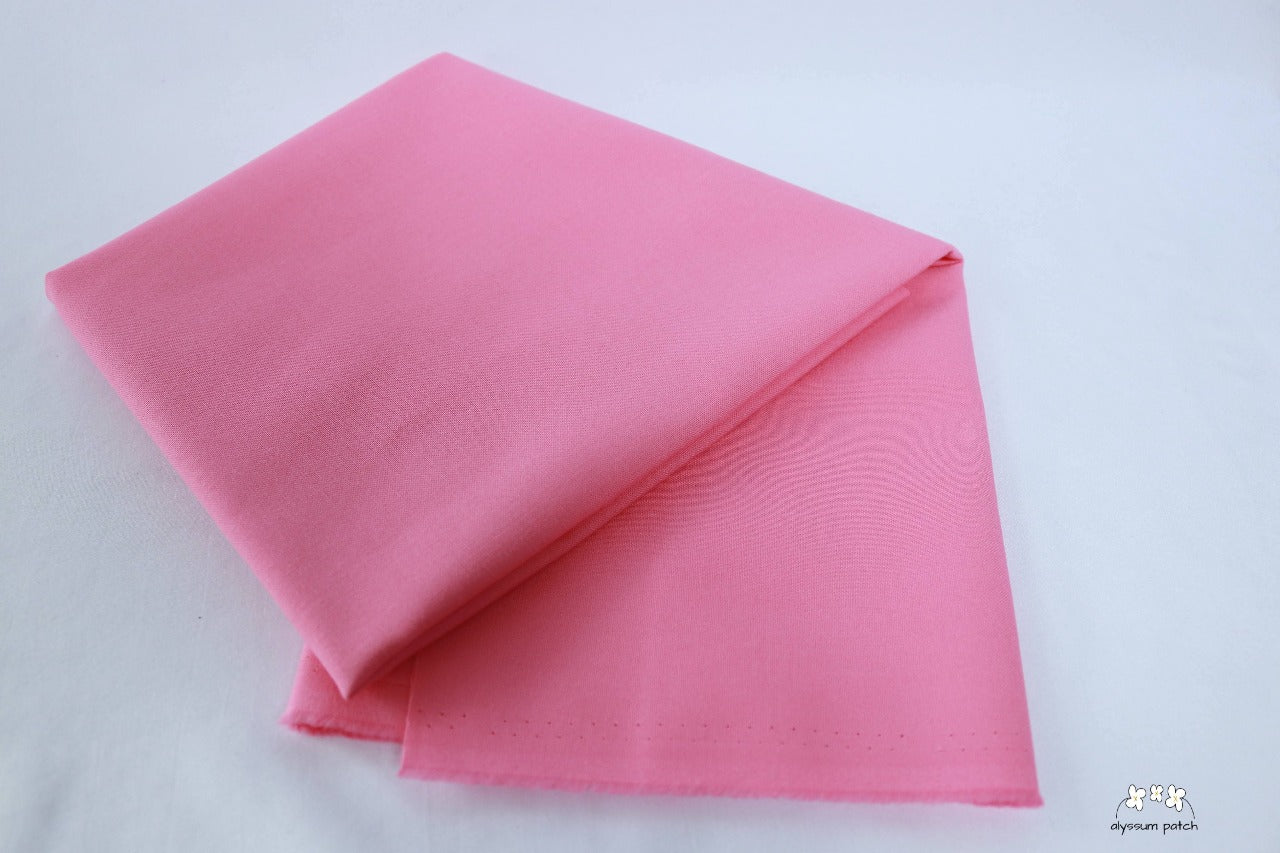 Kona Cotton Solids Bubble Gum fabric folded