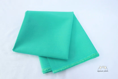Kona Cotton Solids Candy Green fabric folded