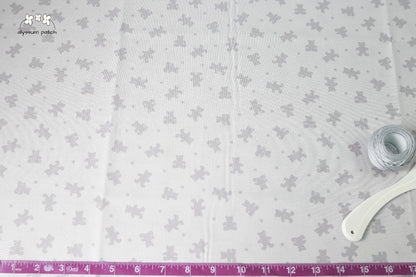 Grey on Grey Bears fabric with measuring tape and sewing tools to show scale of pattern image