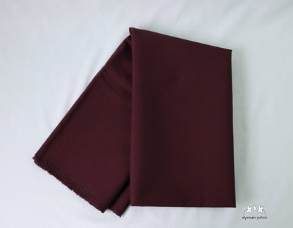 Kona Cotton Solids Raisin fabric folded