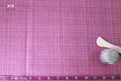 Wildberry Woven fabric with tape measurer and sewing tools to show scale of pattern image