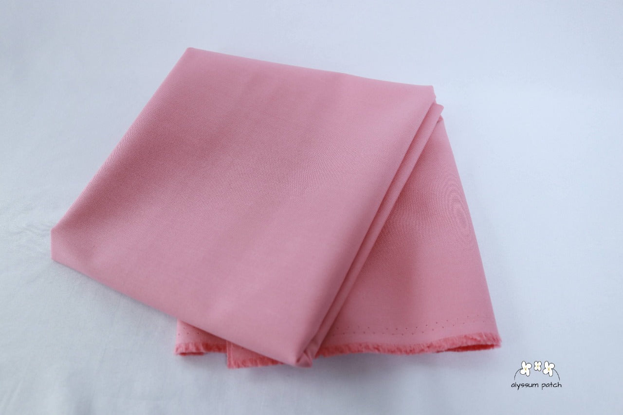 Kona Cotton Solids Wood Rose fabric folded