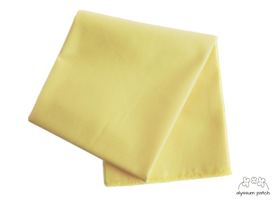 Kona Cotton Solids Buttercup fabric folded