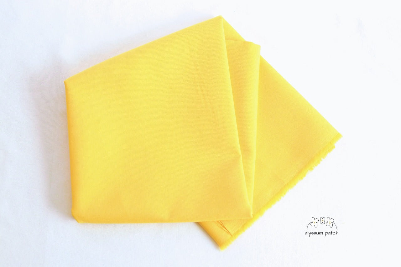 Kona Cotton Solids Canary fabric folded