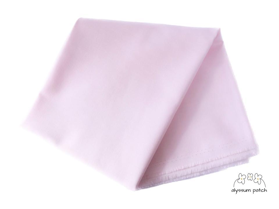 Kona Cotton Solids Pearl Pink fabric folded
